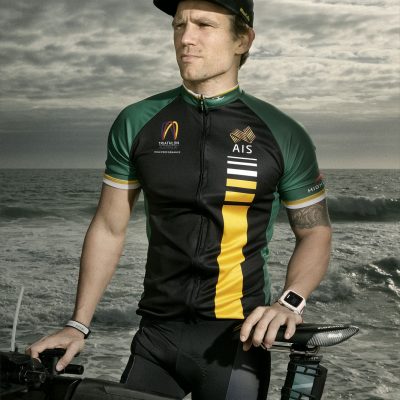 Paratriathlete Brant Garvey, standing with bike in front of ocean, 360kb.